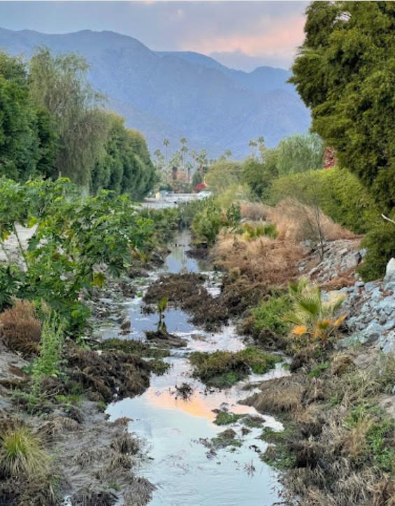 A photo of a polluted river in a desert.